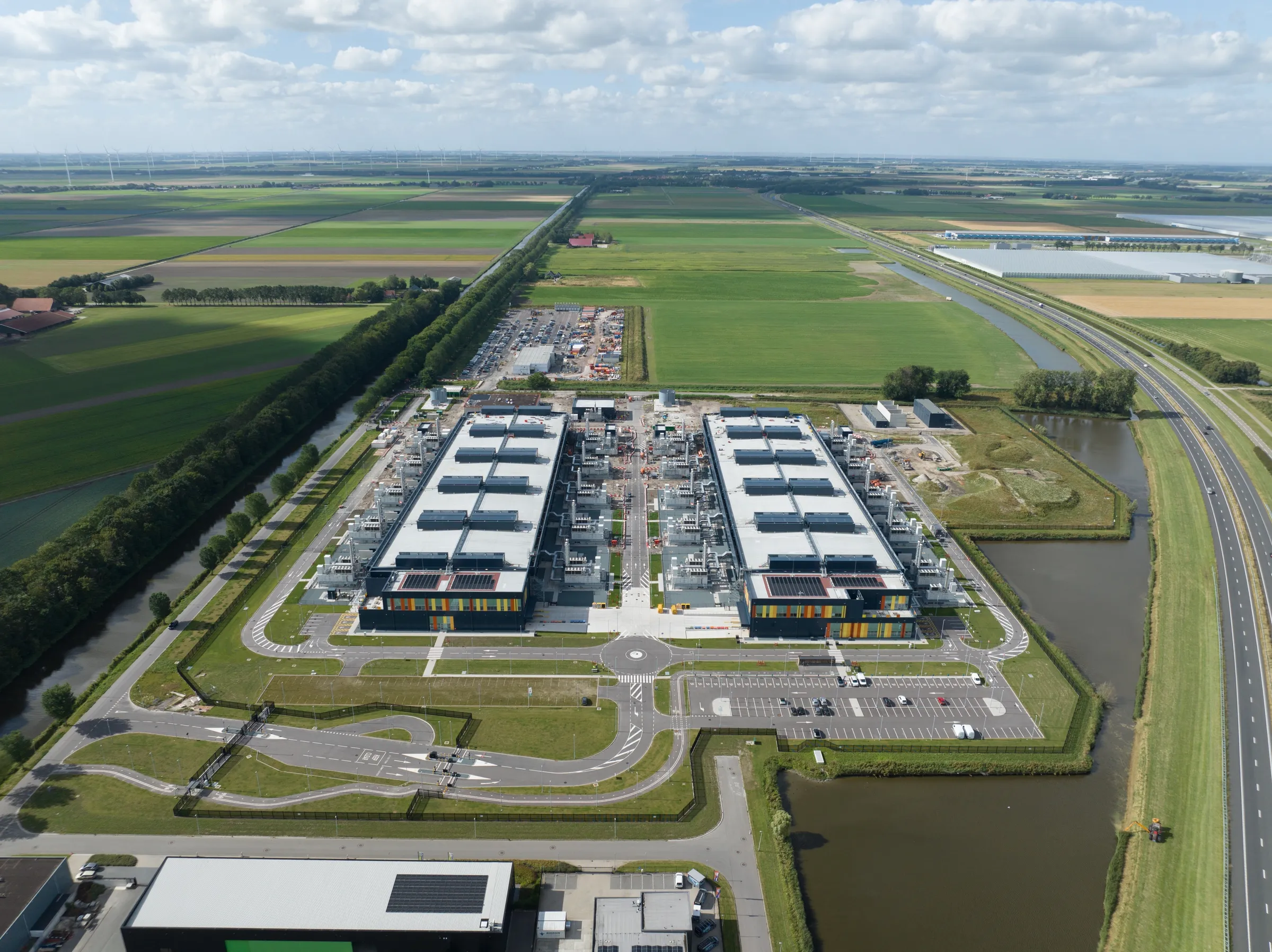 Aerial view of a large data centre campus surrounded by farmland