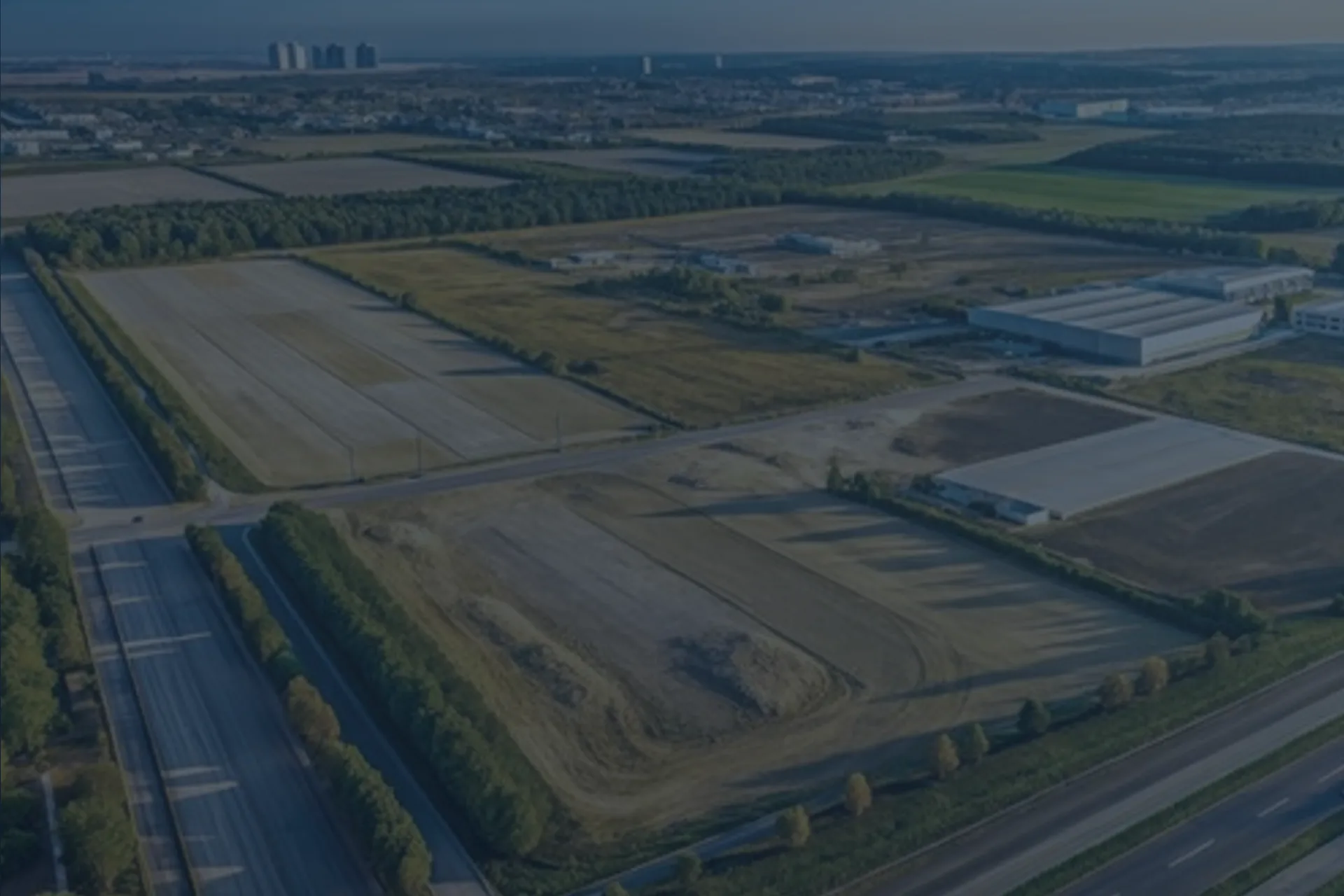 Aerial view of zoned greenfield land beside a motorway